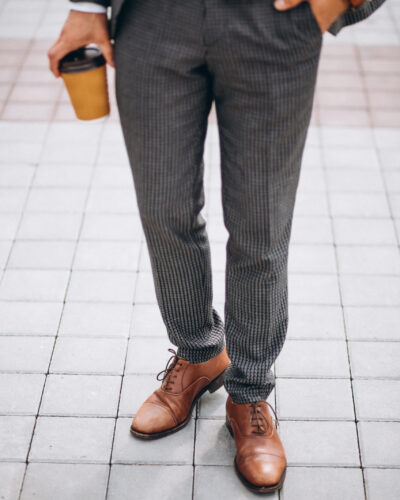 Male suit close up holding coffee in hand