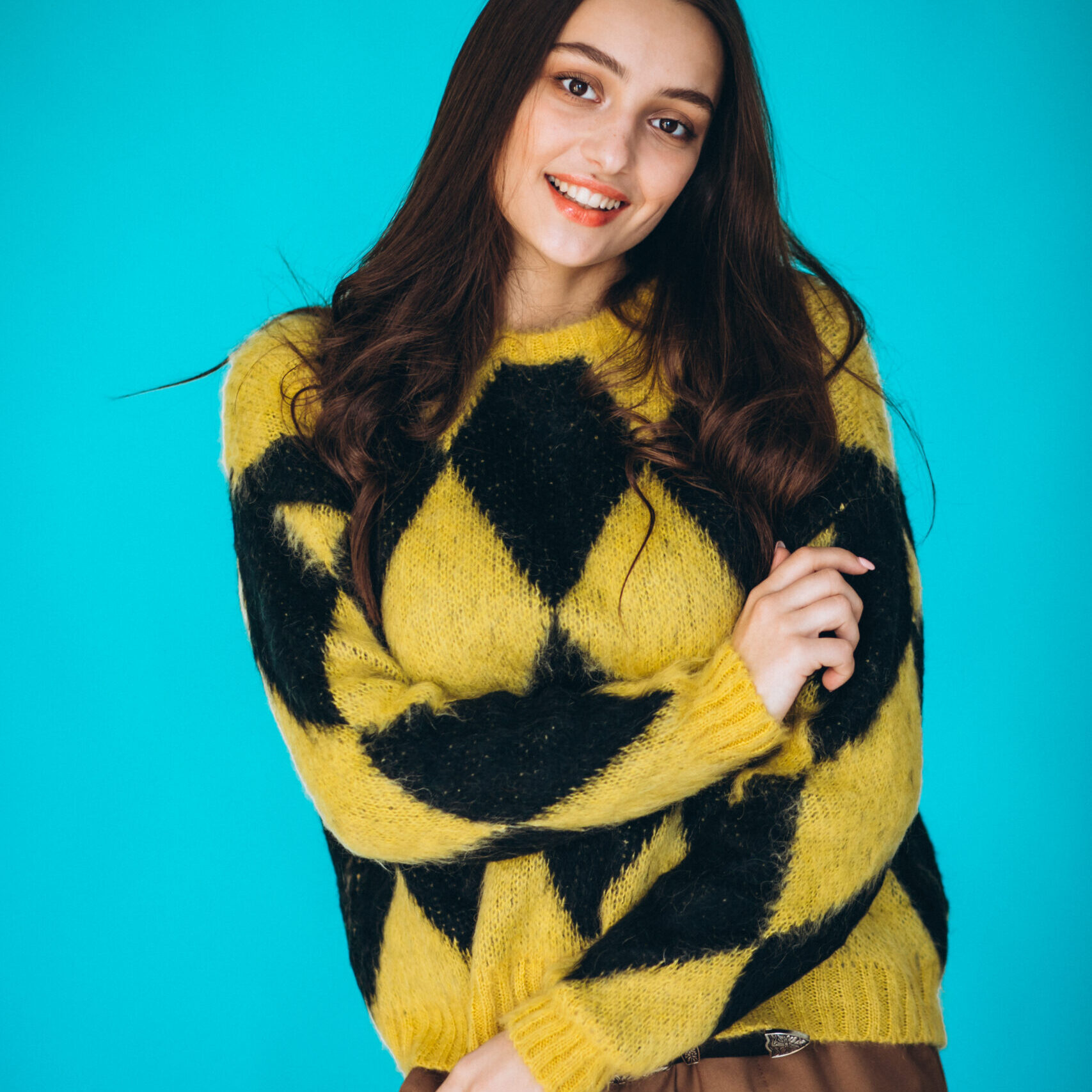 Young woman in a warm sweater in studio