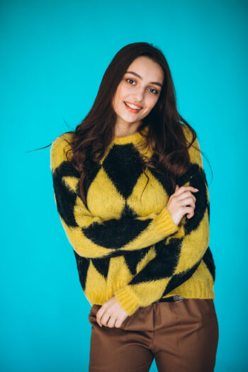 Young woman in a warm sweater in studio Young woman in a warm sweater in studio